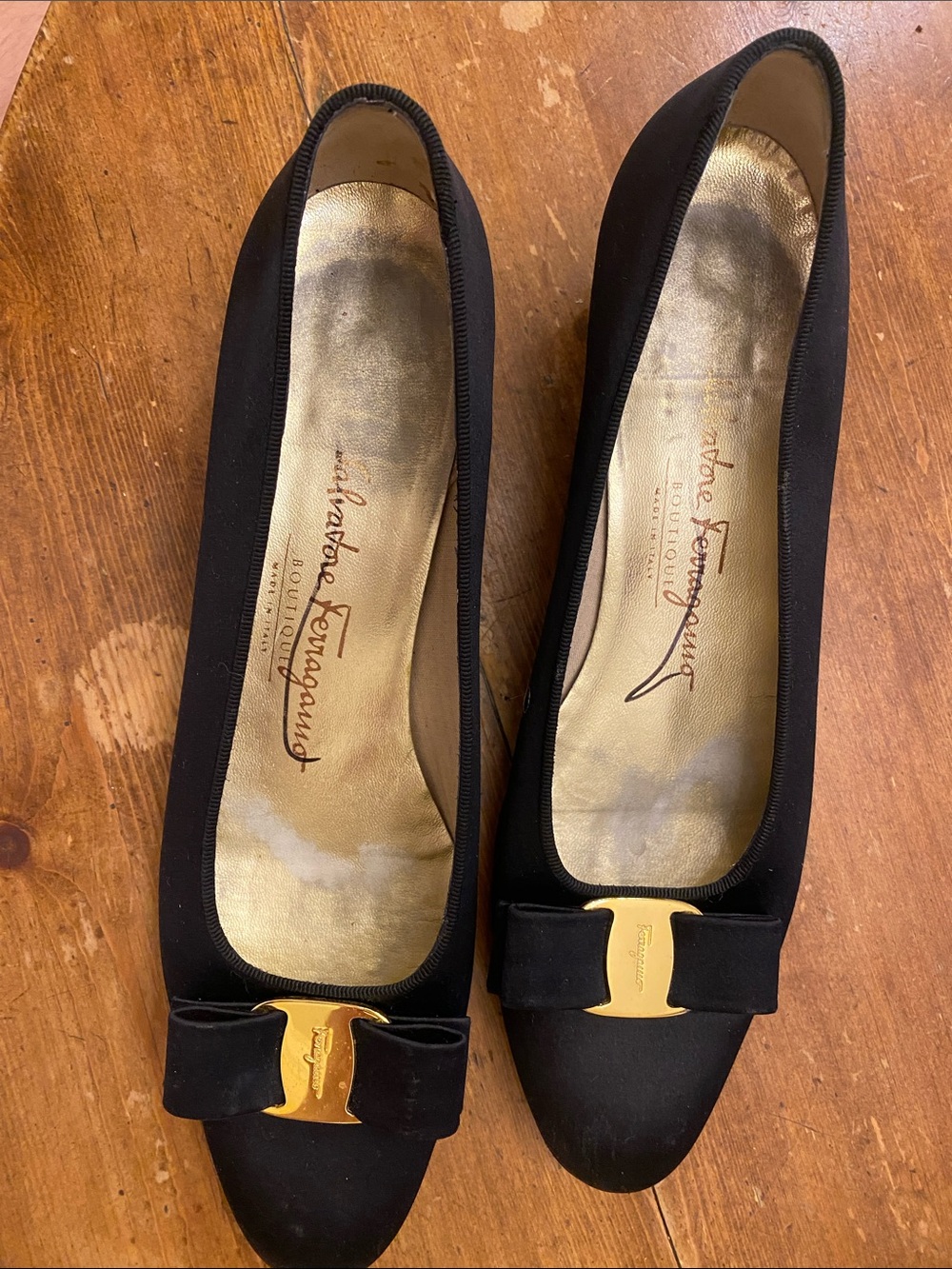 Salvatore Ferragamo Black Flats with Gold Bow Accent